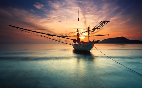 夕阳下大海上的渔船